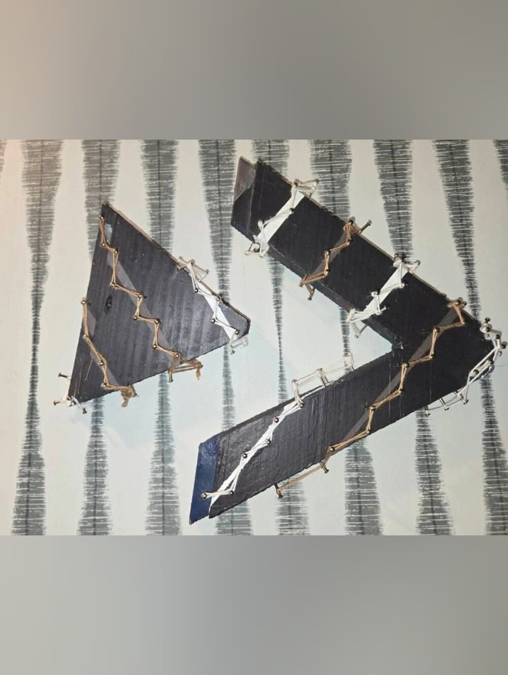 Abstract Wall Art with Black Geometric Strips and Metallic Accents